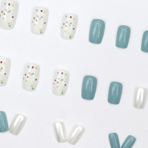 Short square press-on nails with colorful polka dots, matte blue and pearl white designs