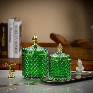 Close-up of green diamond-patterned glass storage jars with elegant gold accents