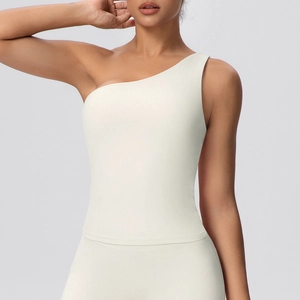 Detailed close-up of off-white one-shoulder yoga top with premium high-stretch fabric texture