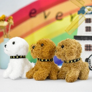 Macro view of three colorful plush teddy dog bag charms featuring starry collars