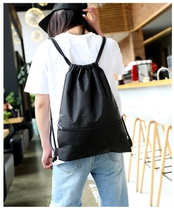Detail of waterproof nylon drawstring backpack with honeycomb texture and zipper pocket