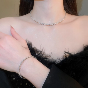 Close-up of elegant silver necklace and bracelet set with sparkling cubic zirconia