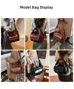 Detail view of large leather hobo bag in burgundy, brown and black with puppy charm