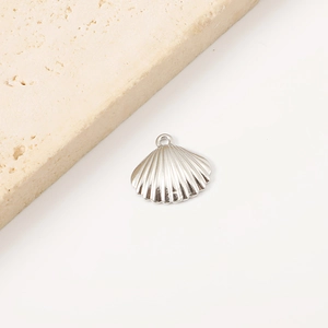 Detailed macro shot of a silver scallop shell pendant made from stainless steel