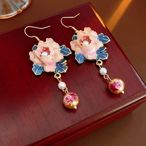 Detail of vintage flower earrings with pink enamel, blue leaves, pearls and gold hooks
