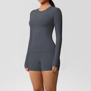 Detail of high-stretch dark grey yoga set featuring long-sleeve top and high-waisted shorts