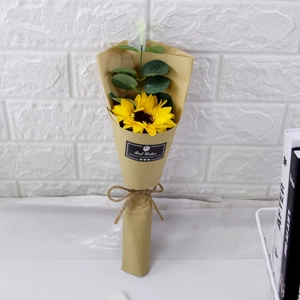 Detail of soap sunflower bouquet in kraft paper with Best Wishes sticker and green leaves