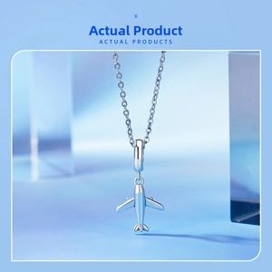 Detailed view of the S925 sterling silver mini airplane pendant on an O-chain necklace
