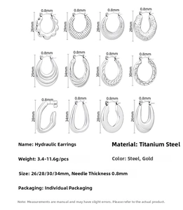 Macro view of assorted titanium steel hoop earrings with various textured oil-pressed designs