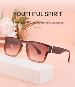 Detail of square frame sunglasses in red-brown gradient on minimalist geometric prop