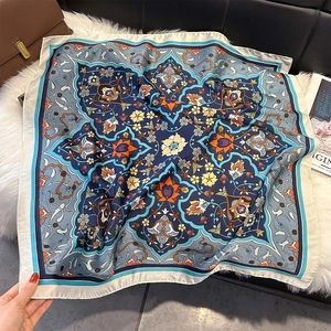 Detailed close-up of navy blue silk-like square scarf with vintage floral ethnic pattern