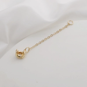 Detail of 18K gold-plated sun and moon extension chain with U-shaped jewelry clasp