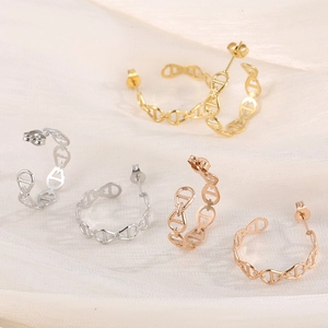 Macro detail of pig nose link earrings in gold silver and rose gold plated titanium steel