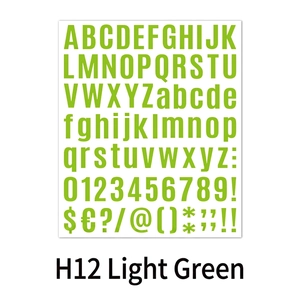 Close-up of light green DIY alphabet and number stickers for creative scrapbooking crafts