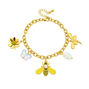 Gold plated stainless steel bracelet with butterfly bee and flower charms on white background