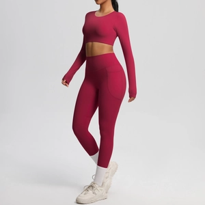 Detail of high-waist yoga leggings with side pockets in magenta brushed fabric