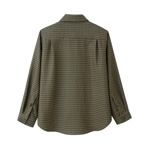 Detail view of plaid shirt back featuring curved hem and pleats on brown woven fabric