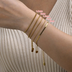 Detail shot of various gold-plated titanium steel chain bracelets with width markings