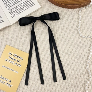 Elegant long black satin ribbon bow hair clip with a French vintage aesthetic look