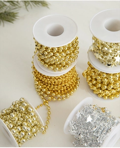 Detail of gold and silver star-shaped bead chains for DIY Christmas tree decorations