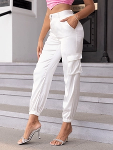 Detail showing white satin cargo pants with side flap pockets and elastic cuffs