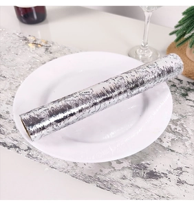 Detailed macro view of silver bronzing mesh table runner with metallic foil texture and shine