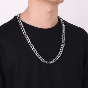Polished silver cuban link chain for men with vintage engraved pattern clasp detail