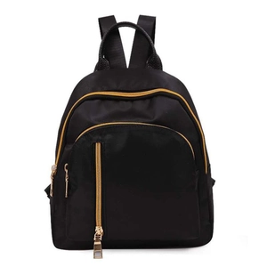 Front view of black nylon mini backpack featuring polished golden metal zippers on white background