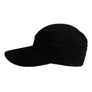 Detail view of the black pleated sun visor hat showing its soft elastic fabric and texture