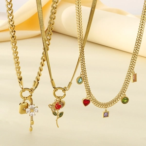 Gold stainless steel red rose necklace set with zircon pendants on beige fabric
