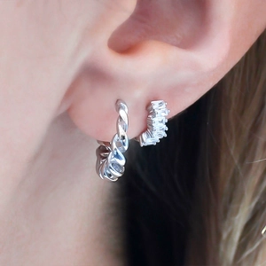 Elegant S925 silver twist hoop earrings with sparkling rhinestones worn by a model