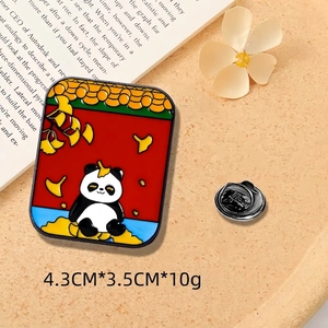 Detail of panda enamel pin with ginkgo leaves and red background, 4.3cm x 3.5cm size