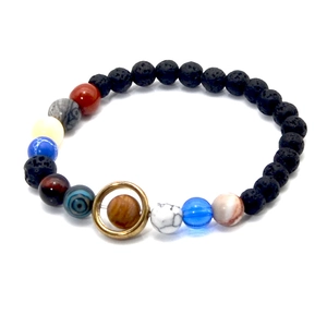 Detail view of solar system lava rock bracelet with planet beads and golden Saturn ring
