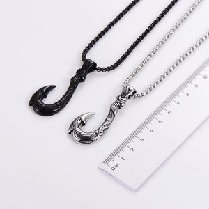 Detail view of 4.5cm black and silver fish hook pendants with vintage texture and ruler