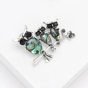Elegant silver owl brooch featuring colorful natural abalone shell and black rhinestones