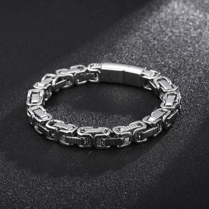 Macro detail of silver titanium steel Byzantine chain bracelet with square clasp link