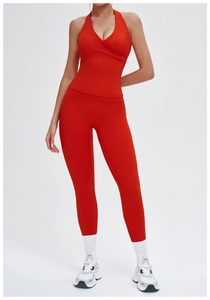Detail of red high-waist yoga leggings and halter neck top with moisture-wicking fabric
