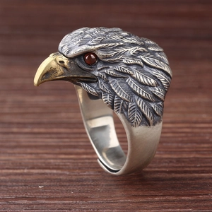 Close-up of vintage eagle ring featuring s925 silver feathers and a red gemstone eye
