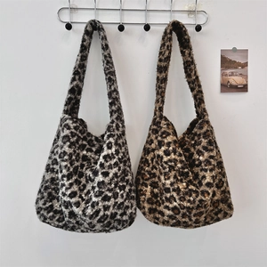 Close-up of leopard print faux fur tote bags in grey and brown plush textures
