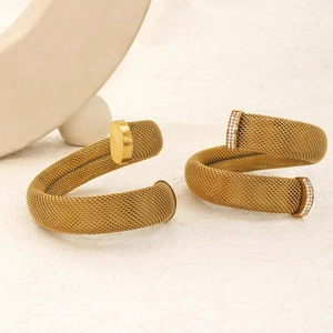Detail of gold braided mesh bracelets with sleek ends and crystal pavé accents