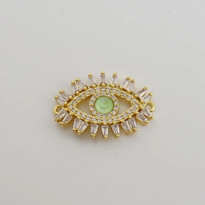 Detailed view of 18K gold plated evil eye connector with green gemstone and white zircons