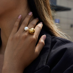 Elegant gold titanium steel ring featuring a large white pearl and polished golden ball