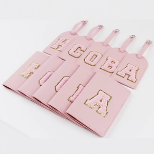Detail of pink PU leather passport holder and luggage tag with chenille letter patches