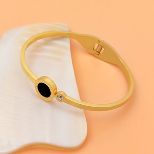Elegant gold titanium steel cuff bracelet featuring black shell inlay and Roman numerals