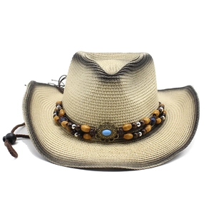 Detail of western straw hat with gradient spray paint edge and turquoise bead band