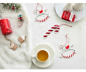 Festive Christmas iron ornaments including Santa mailbox and candy canes on white background