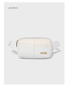 Macro view of white quilted PU leather chest bag with golden logo plaque detail