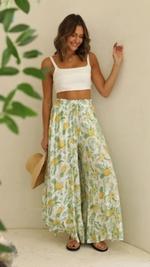 Detail of high waist wide leg pants with pineapple print and white halter crop top