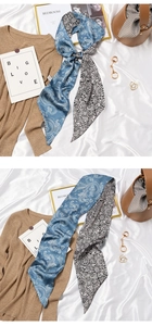 Flat lay of blue paisley and black mandala silk scarf styled with a bucket bag