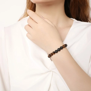 Detail of 8mm natural tiger eye and lava stone beads on an adjustable woven bracelet